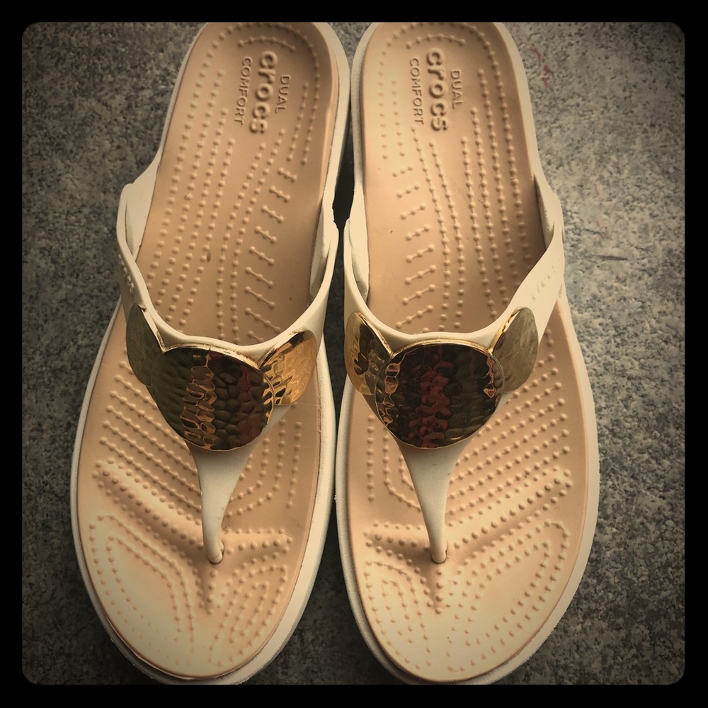 White crocs dual comfort sandals with gold accents